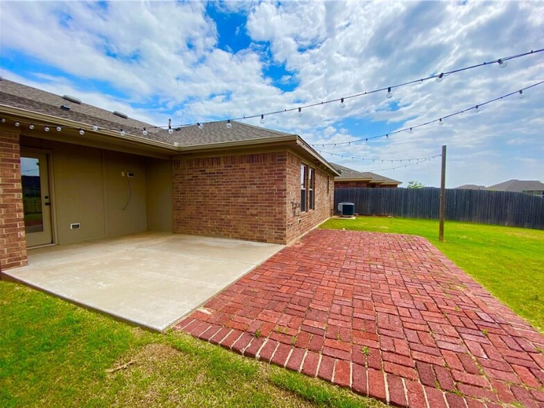 Backyard with extended pavers, outdoor lights, and pond view - 2452 NW 190th St