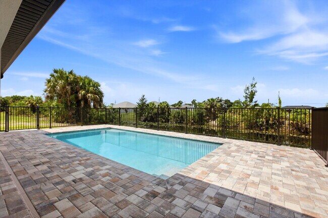 Building Photo - New 3/2 Pool Home for Rent on Canal, Fenced Yard, Pets Welcome. Your Dog Approves of This Backyard