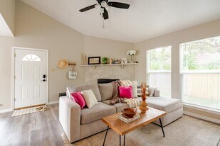 Living room with Fireplace, large window and new blinds throughout. - 6307 Okner Ln