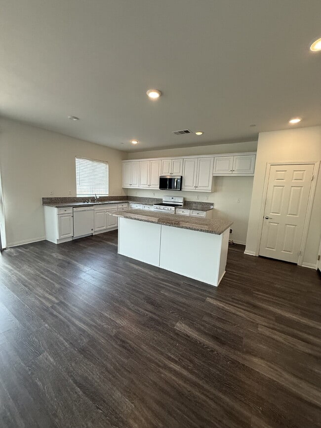 Building Photo - New flooring & paint!  Large backyard - landscaped and ready for garden!   Community pool, fitnes...