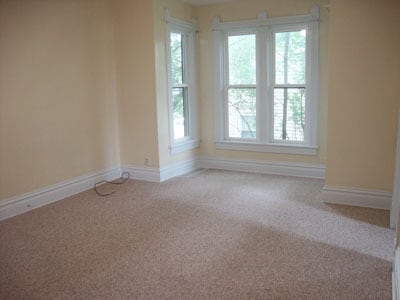 Living room with bay windows as seen from kitchen doorway. - 512 S Center St