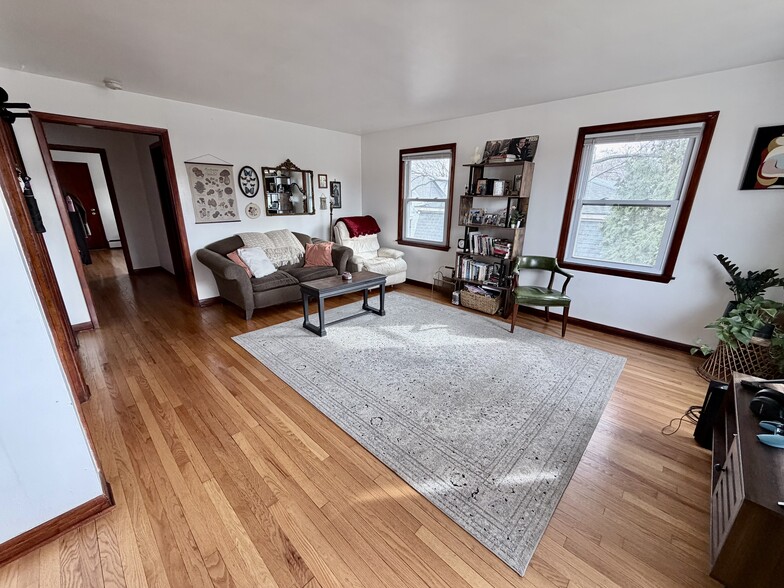 Living room with lots of natural light, side windows face south - 2113 N Sherman Ave