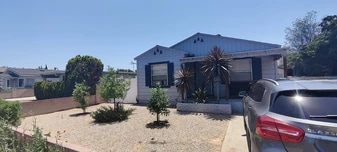 Home entrance, Front yard, patio, and designated parking space on driveway. - 4092 Howard Ave