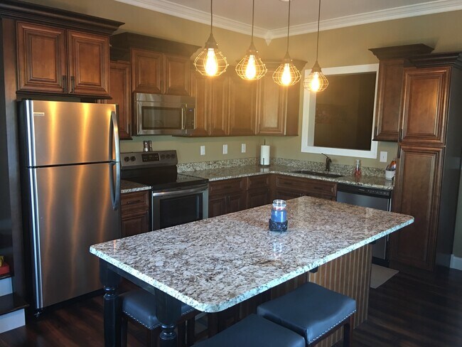 Spacious eat-in kitchen with custom cabinets, granite countertops and SS appliances. - 1023 Kidron Way