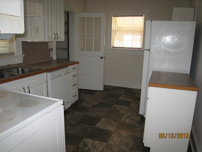 Kitchen to laundry room view. - 1911 E 4th St