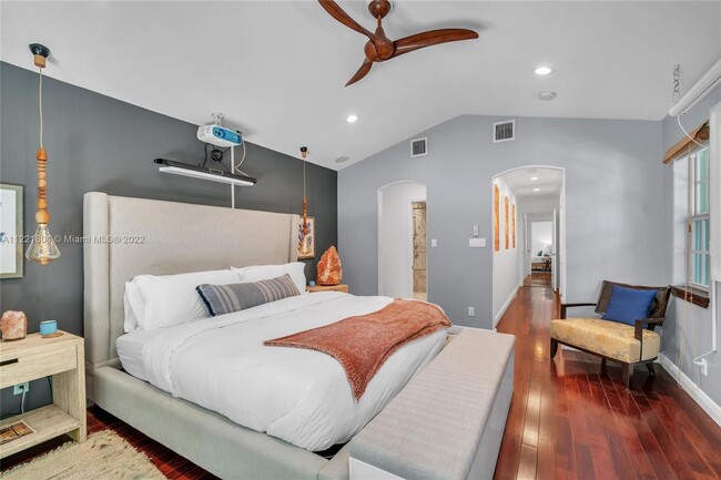 Primary suite with gorgeous wood floors, beautiful pendant lights & modern 3 blade fan - 1109 NE 3rd St