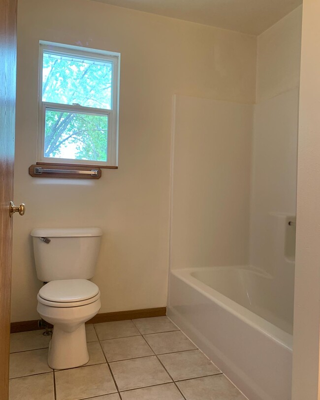 2 full baths - one up and one down. Bath feature tile flooring, new paint - very clean! - 1716 5th St E