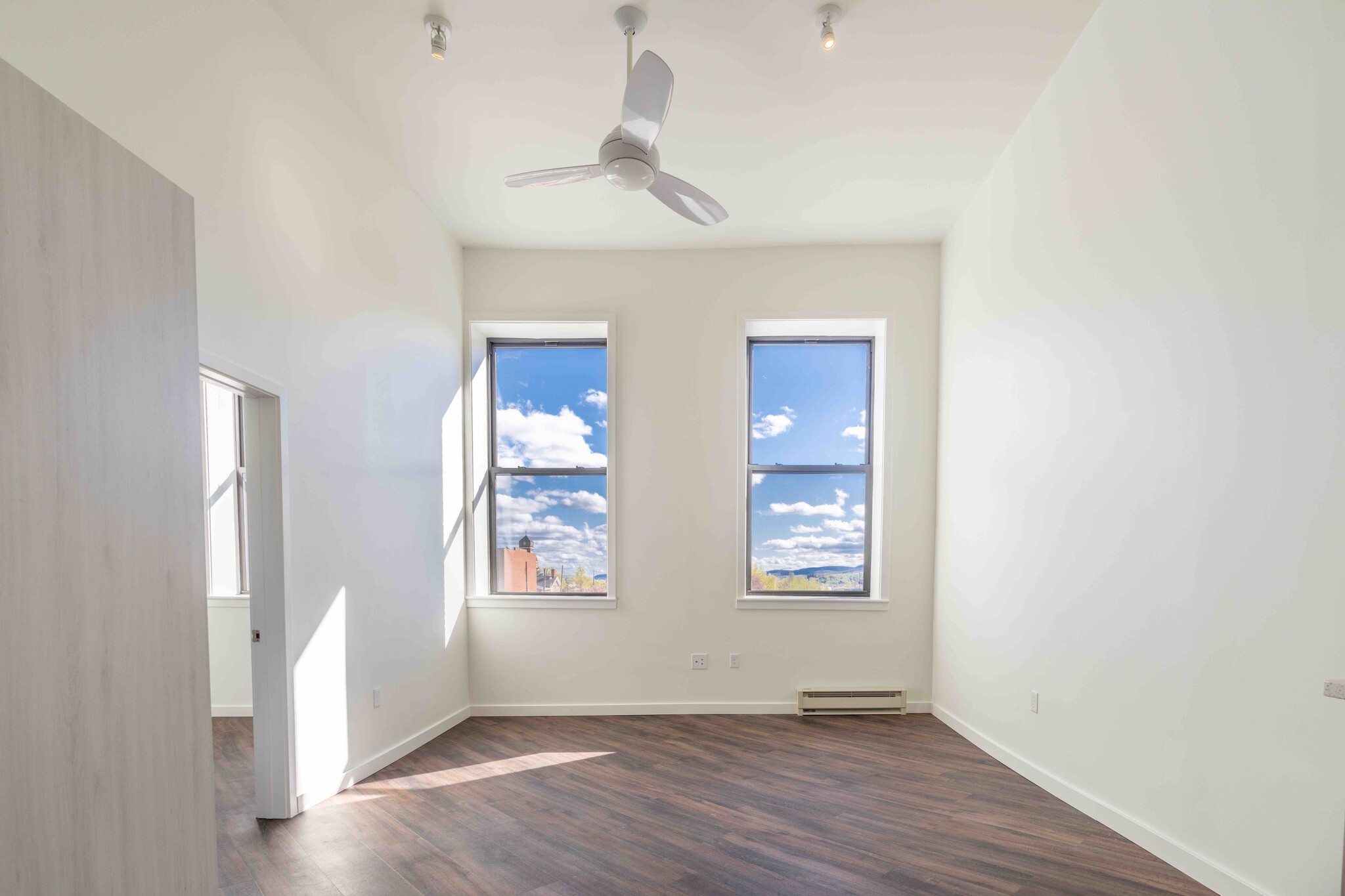 The living room features 12-foot ceilings and large windows - 818 12th St