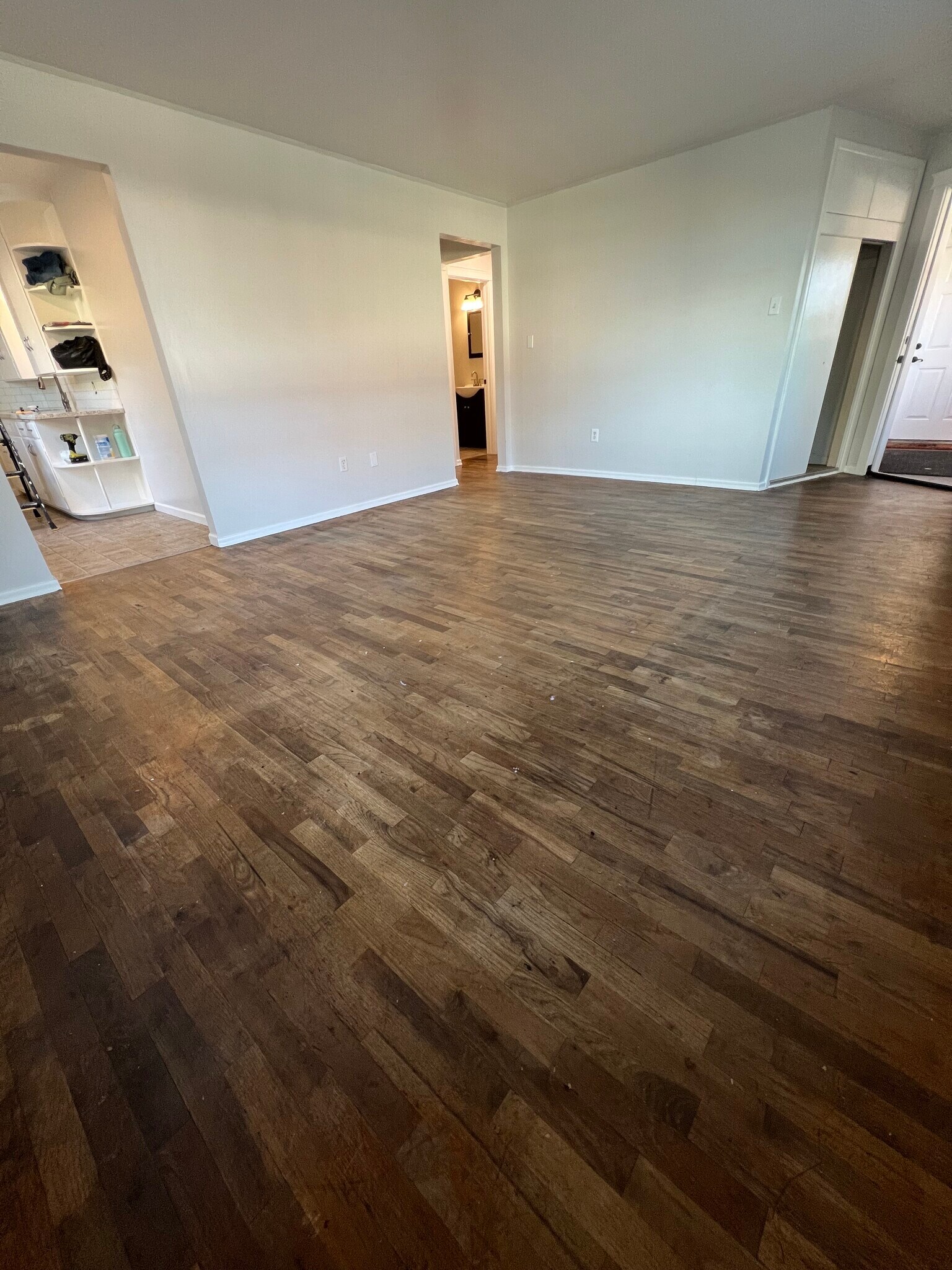 View of living room, into kitchen and hallway. - 620 6th Ave