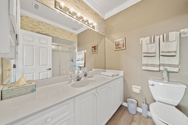 Building Photo - first-floor unit featuring a 2 bedroom, 2 bath fully furnished