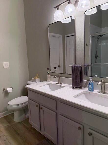 Updated primary bathroom vanity/toilet - 9410 Georgian Park Ln