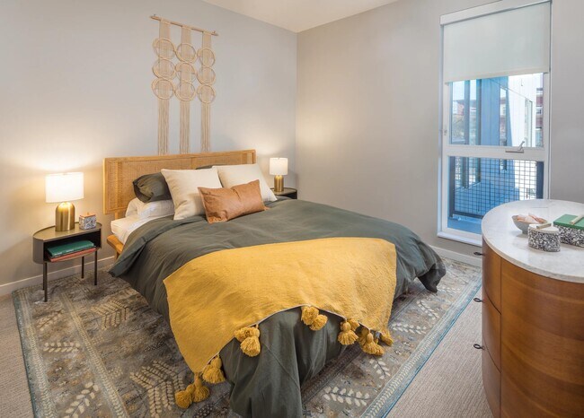 Spacious bedrooms with custom roller shades. - Modera LoHi