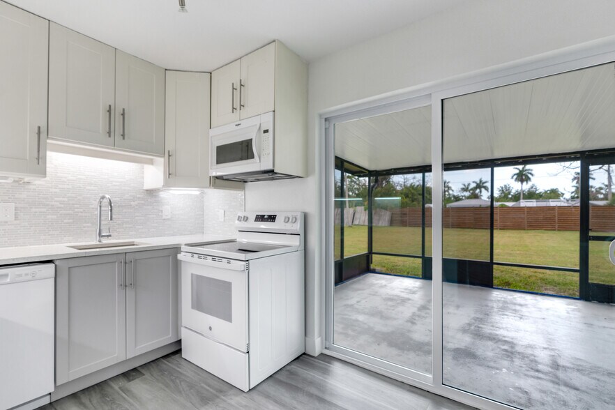 Kitchen looking out to screened porch on the back - 16320 John Morris Rd