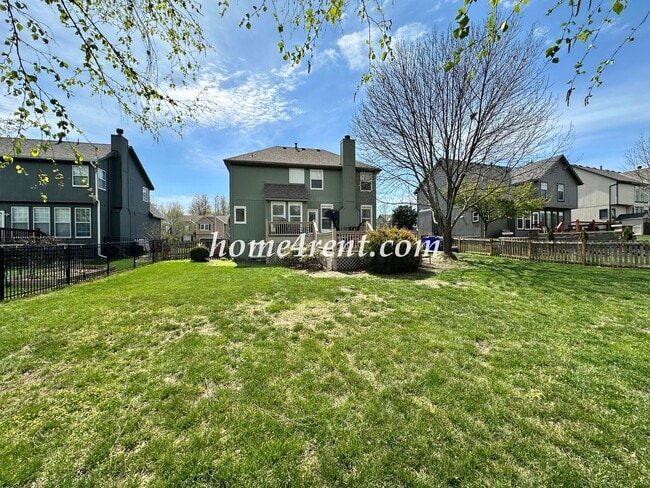 Building Photo - Updated Kitchen, Large Two Tiered Deck, Finished Basement in Blue Valley Schools!