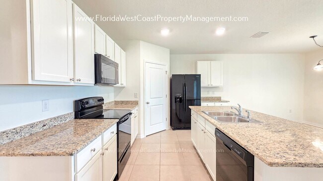Building Photo - MOVE IN READY ! 4 BEDROOM/2 BATH! TILE- LVP THROUGHOUT! LAWN MOWING INCLUDED!