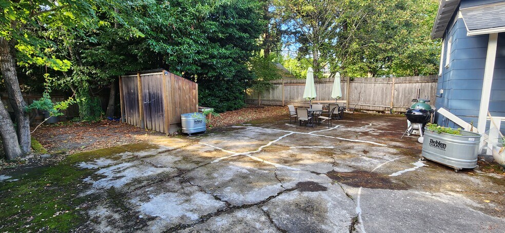Backyard showing gated parking and covered bike storage - 3009 SE 19th Ave