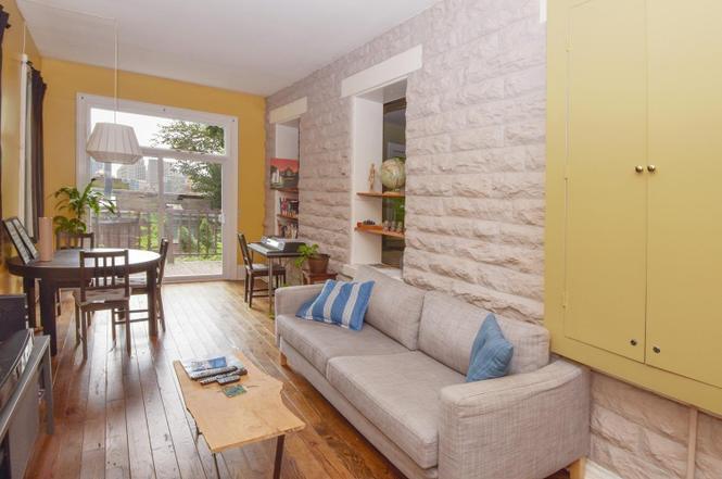 Amazing refinished foundation walls gives the living room a lot of character. - 505 Milton St