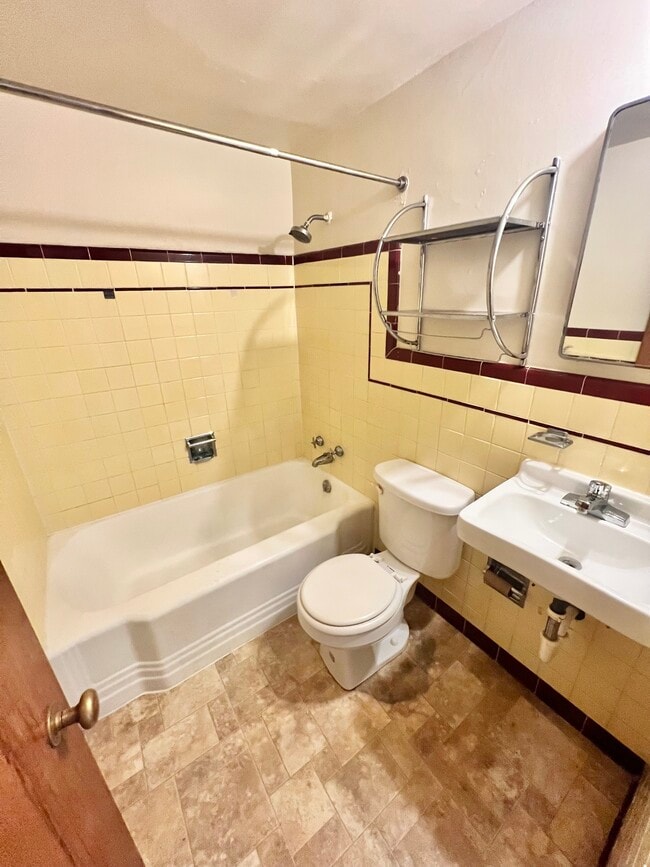 Experience the sleek design and functionality of this contemporary bathroom. - Hillside Apartments