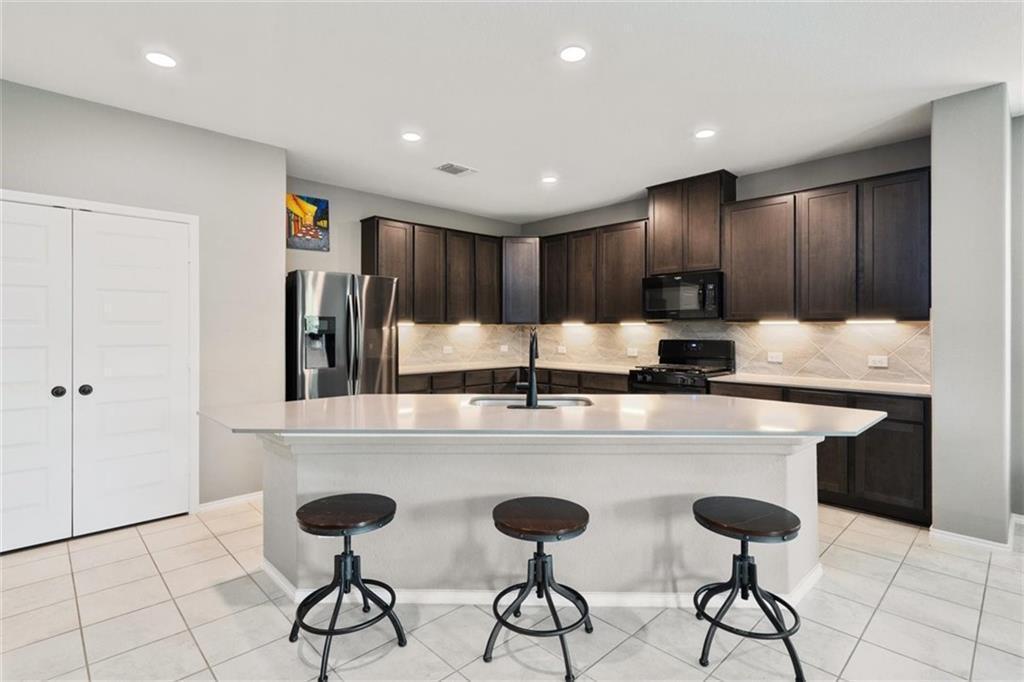 Kitchen with Refrigerator & Quartz Countertop - 3060 Freeman Park Dr