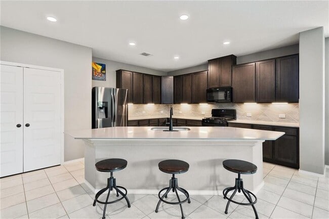 Kitchen with Refrigerator & Quartz Countertop - 3060 Freeman Park Dr