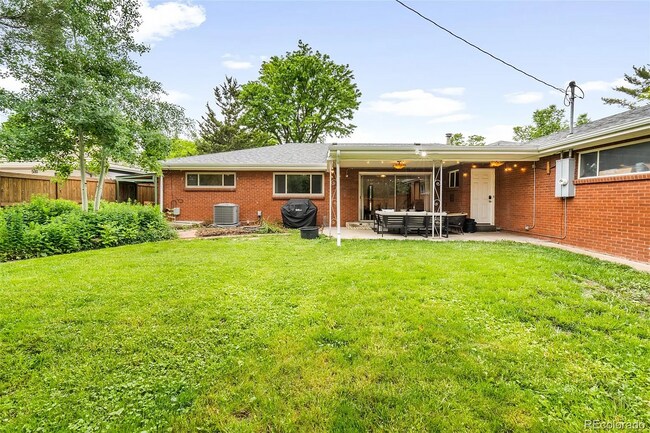 Private, fully-fenced backyard with covered patio. Perfect for a pup to run around! - 516 Monaco Pky