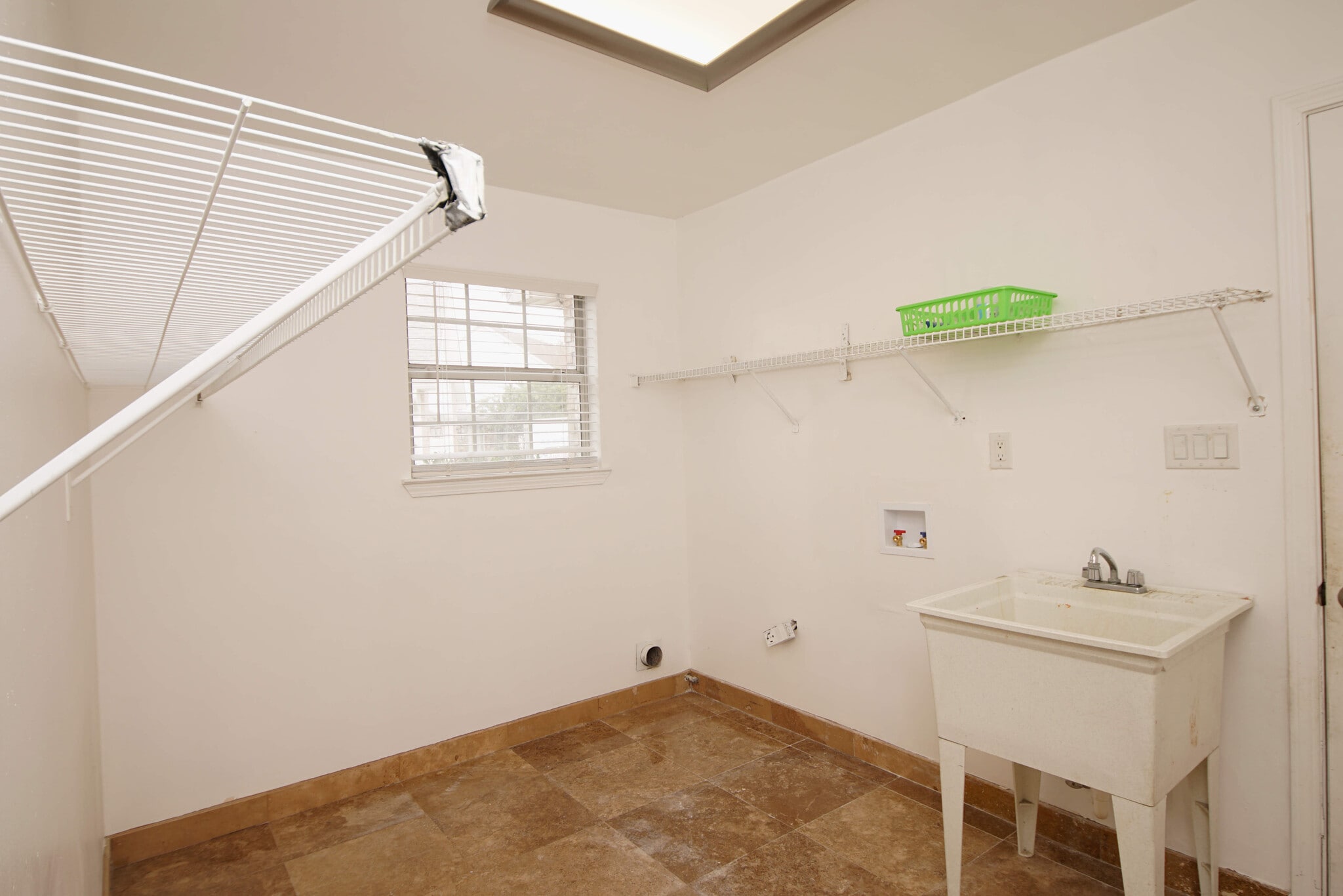 Laundry room with sink and racks for storage - 23 Ruby Cir