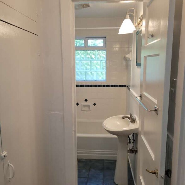 Hallway off living area leads to storage, bath and bedroom 1 on right - 114 Second St
