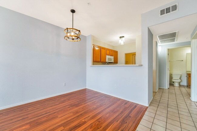 Building Photo - Modern Ground-Level Condo With A One Car Garage in Prime Southwest Location with Resort-Style Ame...