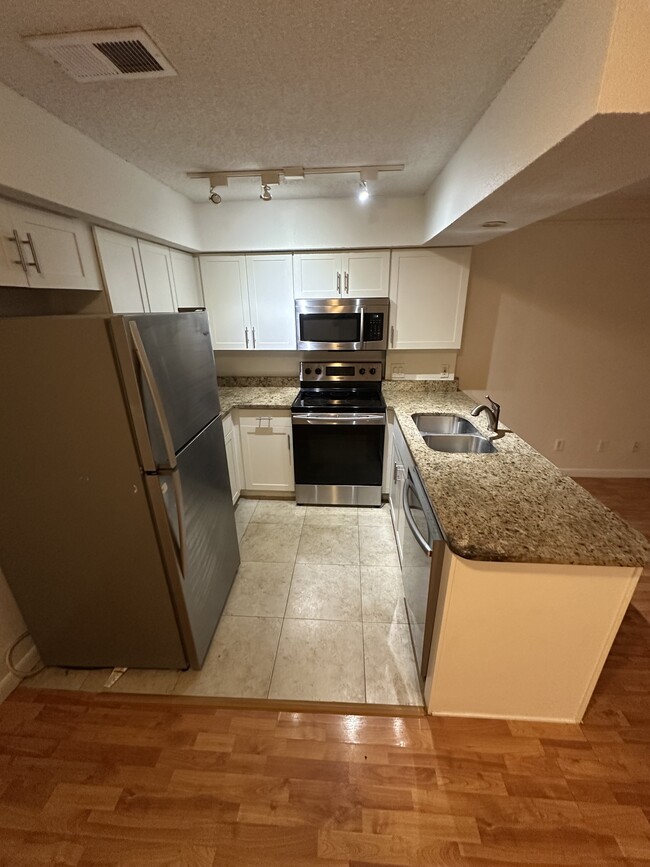Completely updated kitchen with granite counters and stainless steel appliances! - 100 Fairway Park Blvd