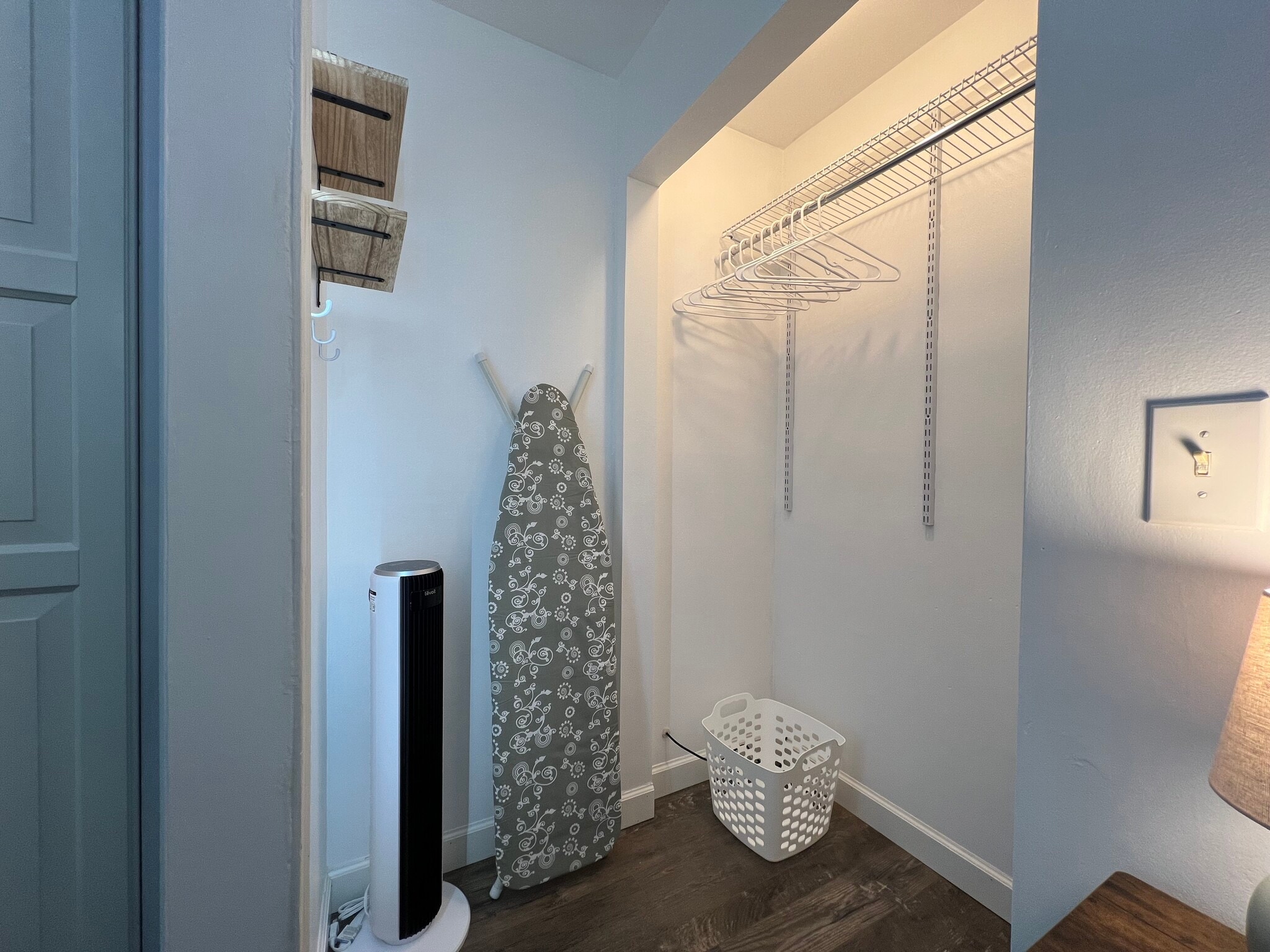 Plenty of shelves, hooks, and hanging storage, an ironing board and iron, and a fan just in case. - 908 Lake Rd