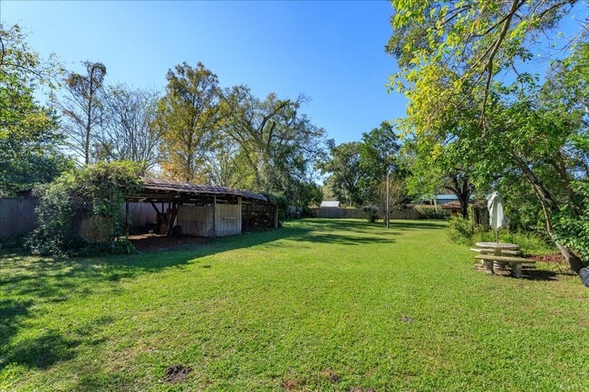 Building Photo - Run don't walk for this one of a kind beautifully maintained Old Florida Charmer on a park like d...