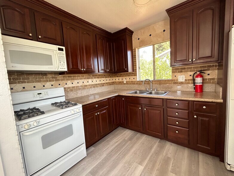 Kitchen microwave with granite countertops, stove and sink - 1156 N Chicago St