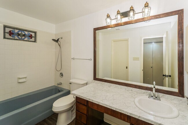 Building Photo - Charming 2-Bedroom Condo in Gated Community Surrounded by Mature Trees