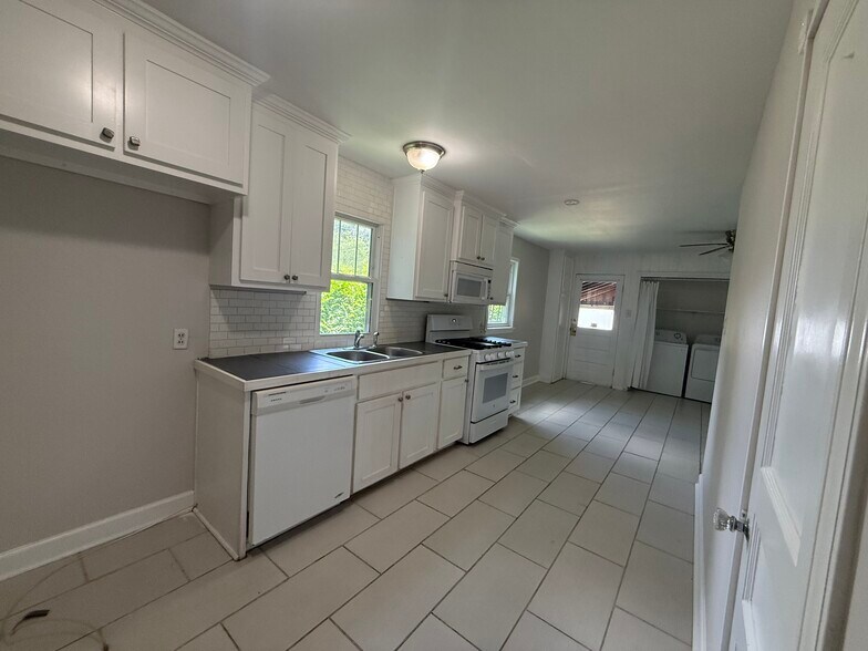 Functional kitchen equipped with a stove, microwave, dishwasher, and ample cabinet space for all you - 823 Rittiner Dr