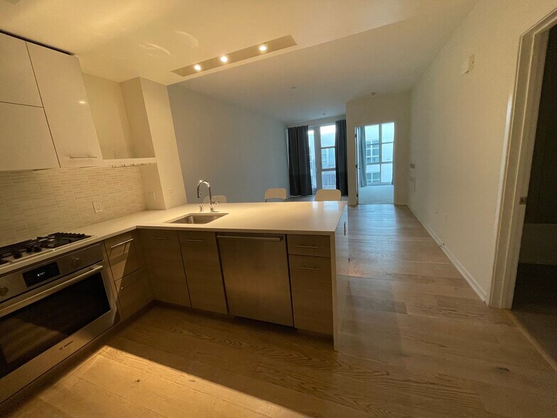 kitchen with door to balcony and bedroom - 451 Donahue St
