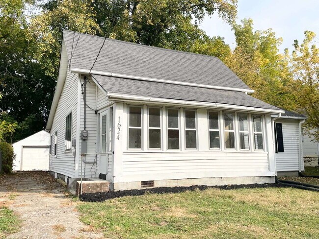 Primary Photo - 4 Bedroom Home with garage/workshop combo (has electricity)