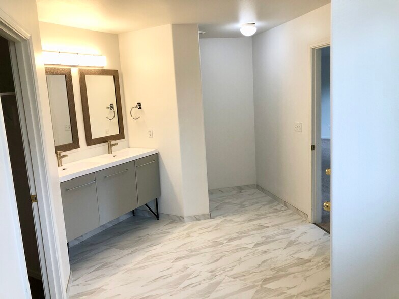 Fully upgraded primary bath with tile floors, vanity and faucets - 1552 SE Ripplewood Ave