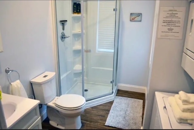 Bathroom with corner shower and stackable washer/dryer. - 1004 Madison Ave