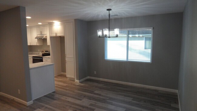 Building Photo - REMODELED 2BR; 1BA end unit condo w/ 1 car garage & 1 parking space