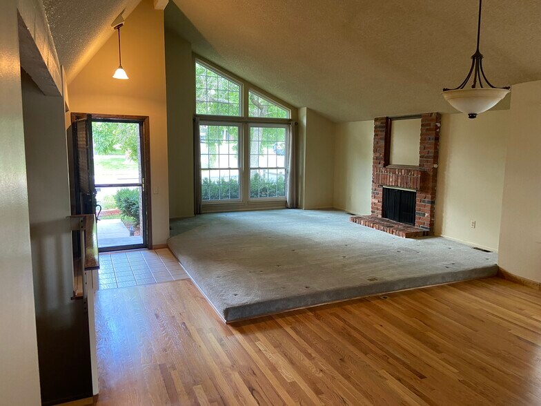 Vaulted ceilings and wood burning fireplace - 8520 W 81st Dr