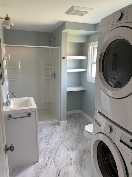 The Bathroom from the kitchen. Visible is the in-unit washer/dryer. - 52 Rose St