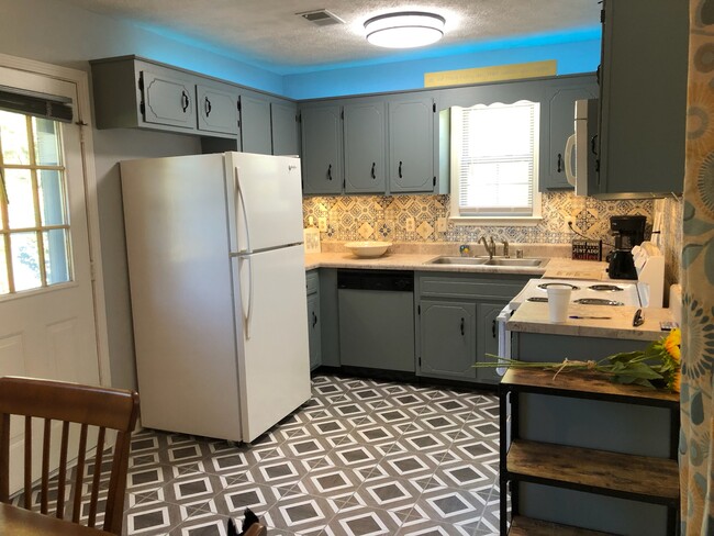 This short term rentals includes this updated kitchen with above and below cabinet lighting! - 1138 Timothy Ave