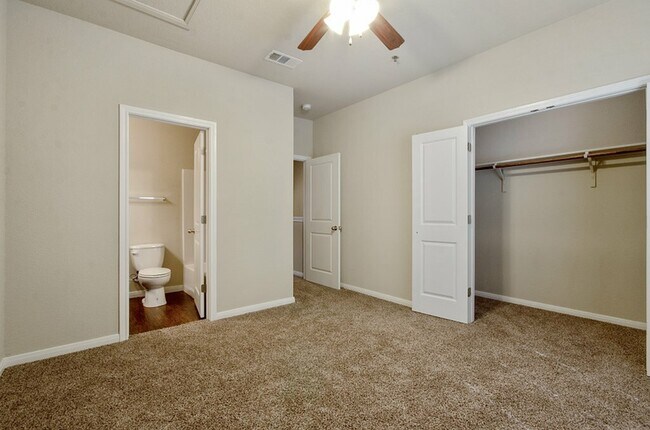 upstairs bedroom with carpet ceiling fan and on suite bathroom - Tinsley Place