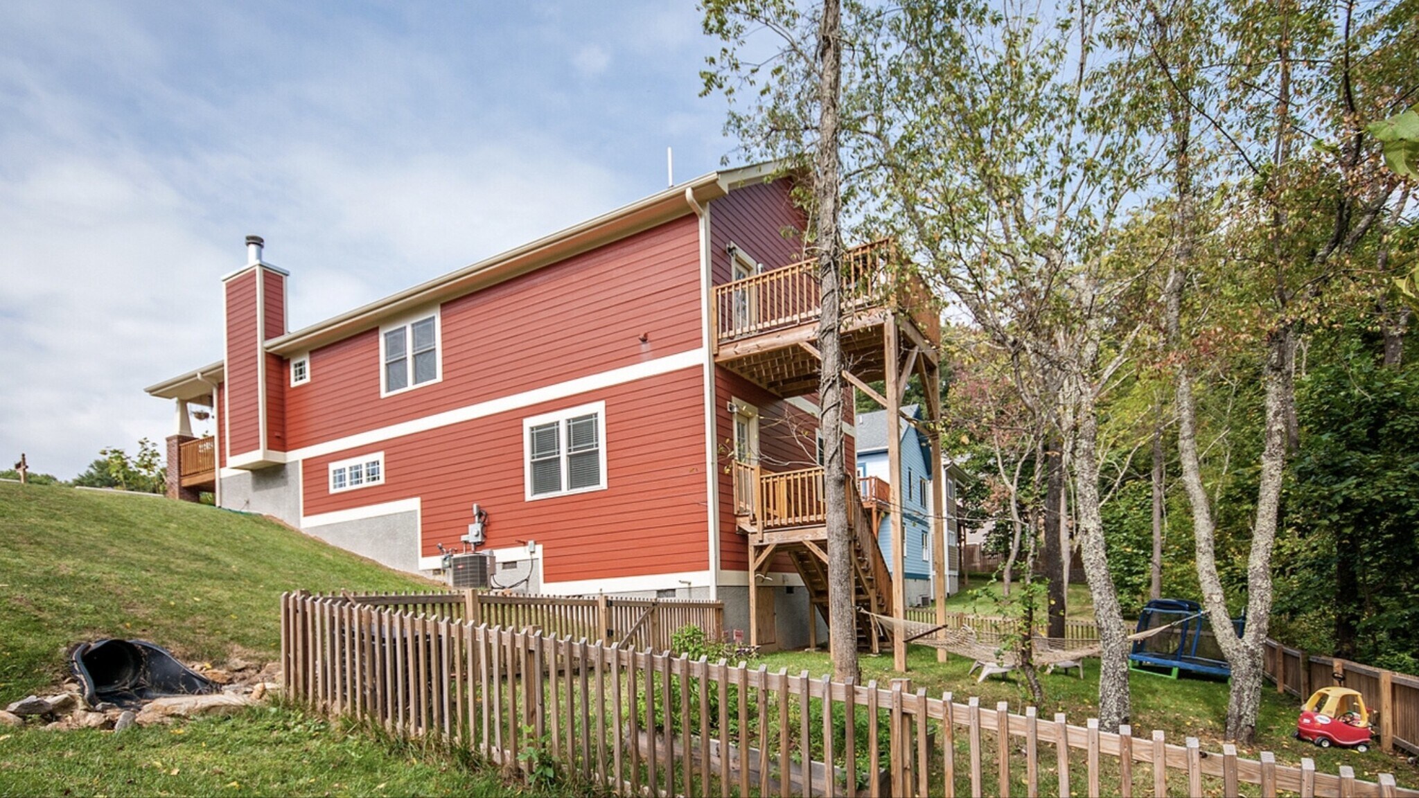 Rear exterior - deck, fenced yard, and finished lower level - 144 Estelle Park Dr