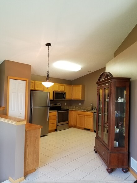 Kitchen with pantry, updated stainless steel appliances and granite countertops - 9719 Xenium Lane N