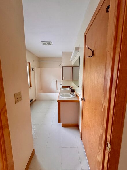 2nd floor full bath with double sink, door to primary bedroom - 113 Penny Ln