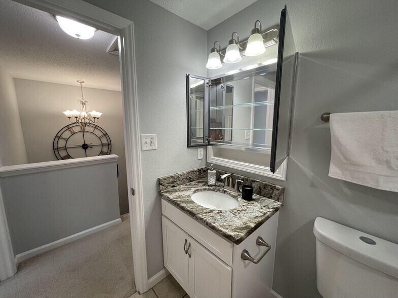 Hall bath with high end medicine cabinet with mirrors throughout and bright lighting - 4204 Whistler Ct
