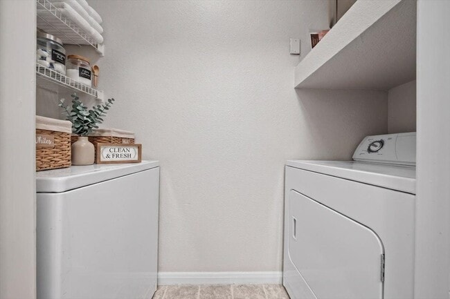 Skip the laundromat—this home features a full-size washer and dryer with built-in shelving for easy, everyday convenience. - Crescent Apartment Homes