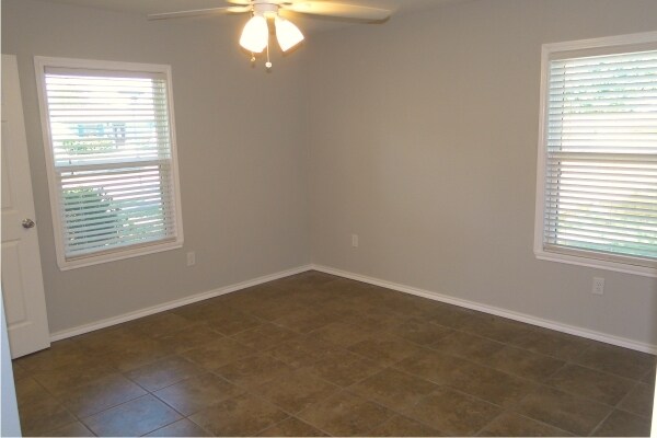 Master Bedroom with window views to front and side yard. - 4115 Robinhood Dr