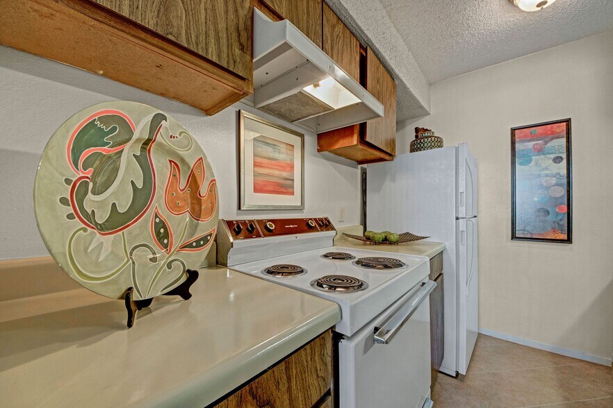 A kitchen with lots of cabinet storage and overhead lighting - Cypress Pointe